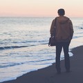 man walking at beach thinking