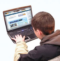 boy in front of laptop surfing on the web internet