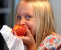 little girl eating apple